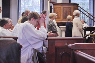 The Rev. David Booman prays at Convention